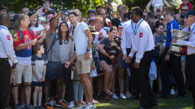 Djokovic takes a moment to chat with fans.
