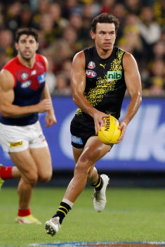 Daniel Rioli gets a kick away.