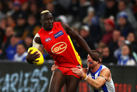 Gold Coast’s Mabior Chol is tackled.