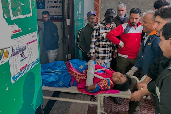 Paramedics carry a wounded tourist on a stretcher.