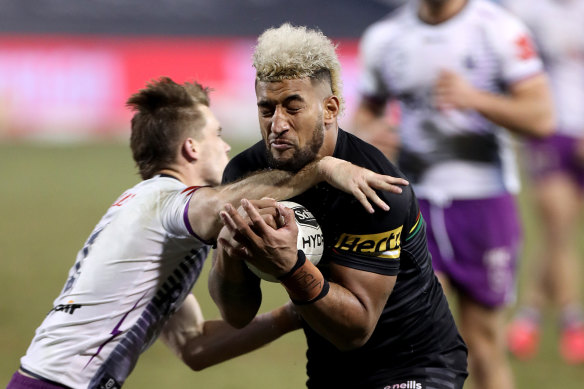 Billy Kikau brushes past Ryan Papenhuyzen to score a try.