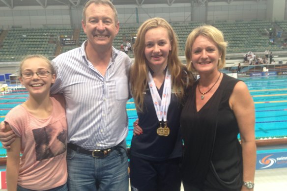 Titmus, 14, with her family (from left: sister Mia, dad Steve and mum Robyn) at the 2015 Age Nationals in Sydney, having won golds in the 200m, 400m and 800m freestyle fi nals.