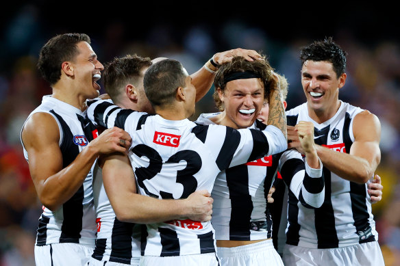 Collingwood celebrate a goal.