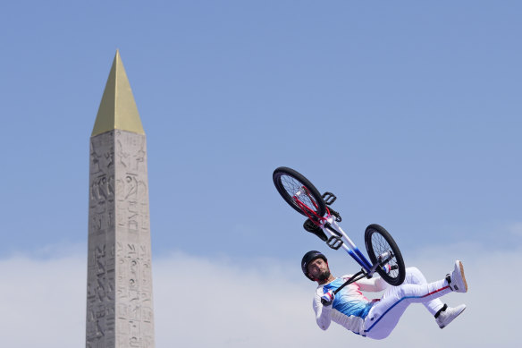 Anthony Jeanjean, of France, performs a trick, with the Luxor Obelisk of La Concorde in the background, during the cycling BMX freestyle men’s park final.