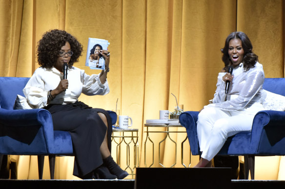 Oprah Winfrey, seen here in 2018 hosting Michelle Obama for her book launch, pulled out of the party ahead of time. 