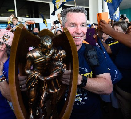 Coach Paul Green holds the NRL trophy on grand final day in 2015 before steering the Cowboys to their only premiership win later in the day.