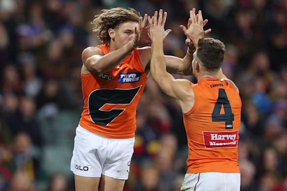Aaron Cadman of the Giants celebrates a goal with Toby Greene.
