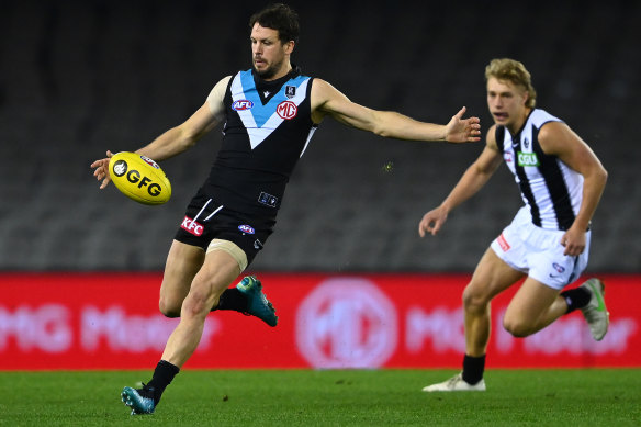 Travis Boak, in his 300th game, gets a kick away during Port Adelaide’s win over Collingwood.