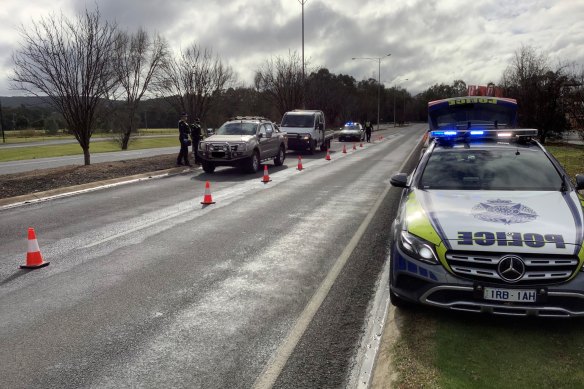 Police monitor cars entering Victoria at Wodonga on Friday.