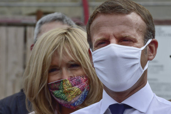 French President Emmanuel Macron and his wife Brigitte Macron wearing protective face masks on Friday.