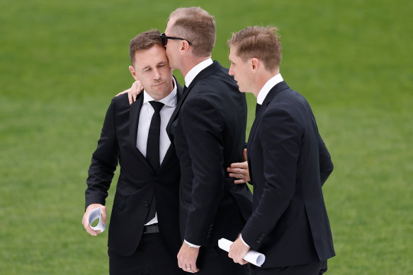 Joel (left), Adam and Scott Selwood farewell their brother, Troy, at GMHBA stadium.