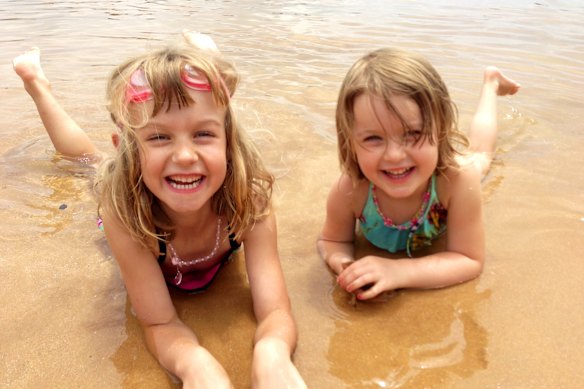 Family tradition: Allegra and Giselle enjoying the sun and sand at Avoca Beach.