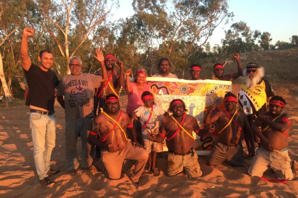 Mayo (far left) takes the Uluru Statement canvas to the Yule River Bush meeting in the Pilbara.