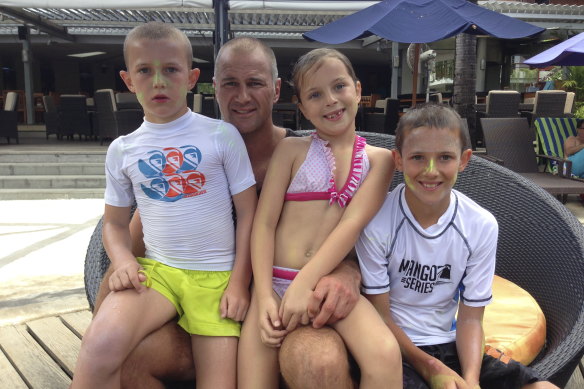 Day one … Brad Arthur with his children Matthew, Charlotte and Jake in Bali in 2013 on the day he was announced as Parramatta coach. 