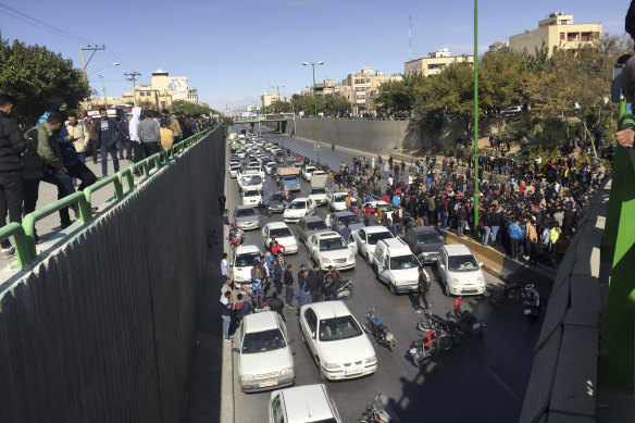 Cars block a street during a protest against a rise in gasoline prices, in the central city of Isfahan, Iran, on Saturday.