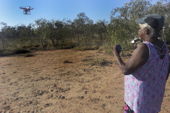 Annie Nayina Milgin, senior Nyikina cultural custodian, directing a drone in the Kimberley as part of research into the story of Woonyoomboo the Night Heron.