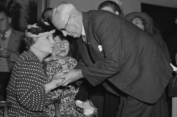 Helen Keller meets Roy Kippax at the Hotel Australia reception. Also pictured is her assistant, Polly Thompson.