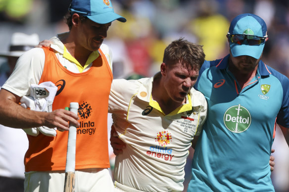 An exhausted and cramping Warner had to be helped from the field after reaching his double century.