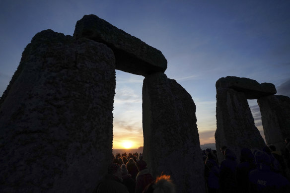 Many mysteries to Britain’s origins. The sun rises behind the Stonehenge prehistoric monument as people gather for the winter solstice celebrations, in Wiltshire, England, on Wednesday.