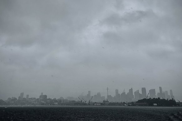 Looking back at the city as heavy rain falls. 