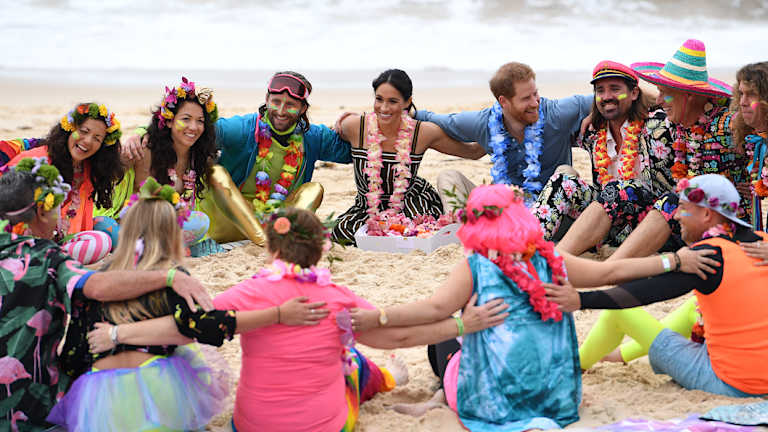 Prince Harry and his wife Meghan take part in a "Fluro Friday" session run by OneWave, a surfing community group raising awareness for mental health and wellbeing, at Bondi Beach.