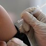 A passenger receives a shot of the Sinovac COVID-19 vaccine during a vaccination campaign at the Jakarta Kota train station in Jakarta, Indonesia, Wednesday, July 28, 2021. (AP Photo/Tatan Syuflana)