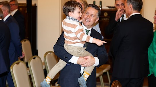 Health Minister Mark Butler with his son at the swearing-in ceremony at Government House.
