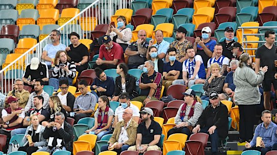 Fans take part in a trial of relaxed COVID-19 restrictions at the Gabba on Monday night.