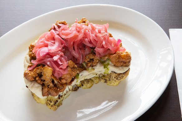 Cauliflower steak comes with cauliflower puree, pickled onions and chimichurri.