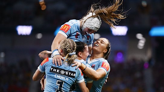 Blues teammates celebrate a try in the second half.