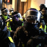Police officers guard the Western District Court after the president’s supporters stormed the building.
