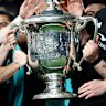 The All Blacks lift the Bledisloe Cup after their victory over the Wallabies.
