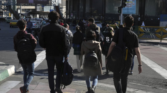A group of young Iranian women cross a street without wearing their mandatory Islamic headscarves in Tehran, Iran, on November 14.