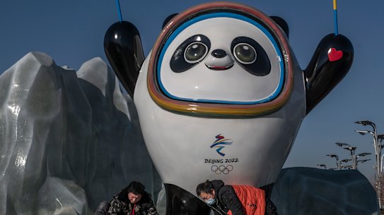 Workers clean the Beijing 2022 Winter Olympics mascot.