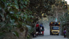 People sit atop a vehicle travelling along a track in Viqueqe. East Timor is opening up more of its land for mining and exploration, and has awarded the majority of the licences to Australian companies.