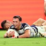 Scott Drinkwater of the Cowboys scores a try against the Broncos.