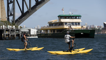 Mark Sedgman and Dan Westwood ride bikeboats on Sydney Harbour.