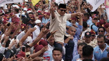 Prabowo greets supporters at a campaign rally in March. 
