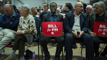 A man holds a 'Bill for PM' sign. 