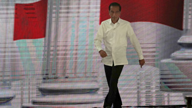 Indonesian President Joko Widodo arrives on stage for the fourth presidential debate.