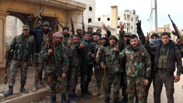 Syrian Government Soldiers Watch As Women Gather Clothes Then