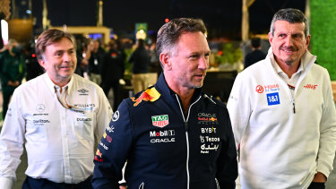 Red Bull team principal Christian Horner (centre), Haas team principal Guenther Steiner (right), and Jost Capito, CEO of Williams F1, leave the pit paddock at the Saudi Arabian grand prix at Jeddah.