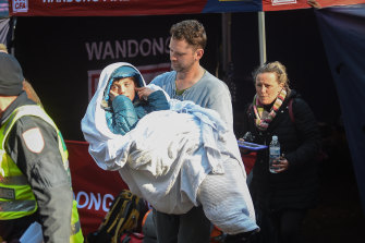 Will Callaghan, in his stepfather's arms, after being found. His mother Penny follows close behind.