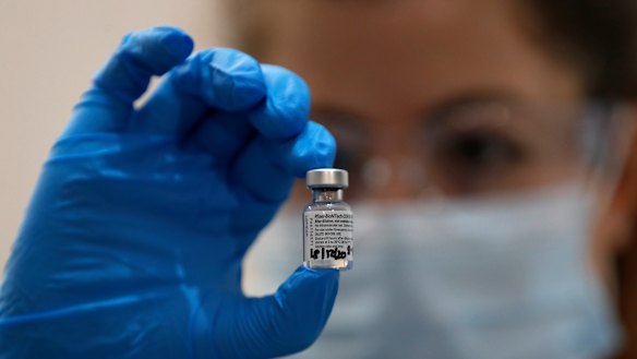 A nurse holds a phial of vial of the Pfizer-BioNTech vaccine - one of two products being rolled out in Australia.