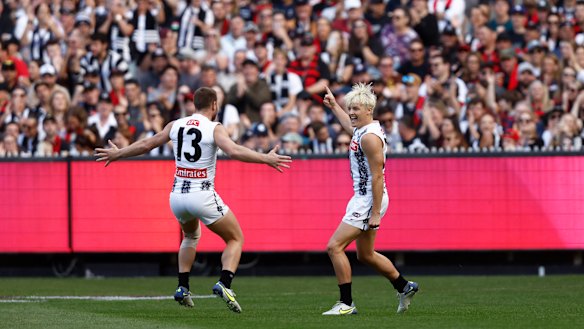 Jack Ginnivan celebrates a goal with teammate Taylor Adams.