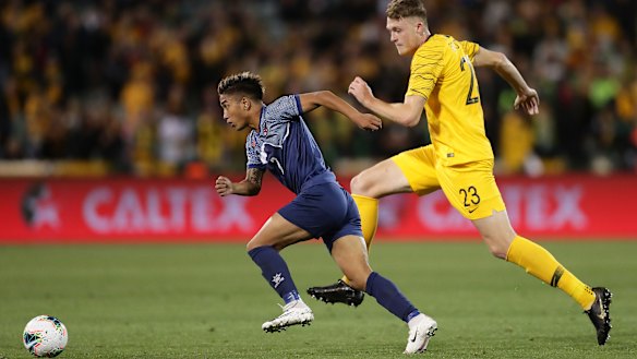 Abhishek Rijal of Nepal takes on Harry Souttar of the Socceroos.