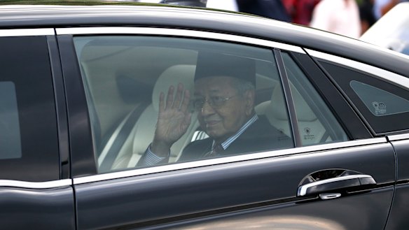 Mahathir Mohamad waves after being granted an audience with the Malaysia's King Sultan Abdullah Sultan Ahmad Shah at the National Palace in Kuala Lumpur.