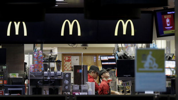 Workers prepare food for drive-through customers as level four COVID-19 restrictions are eased in Christchurch, New Zealand.