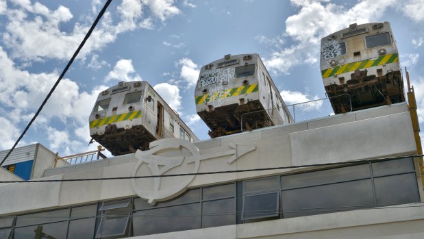 Old Hitachi trains sit on of the top Easey Street building.