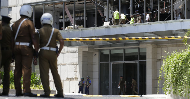 Police and forensic officials at the Shangri-la hotel in Colombo after Sunday's attack.